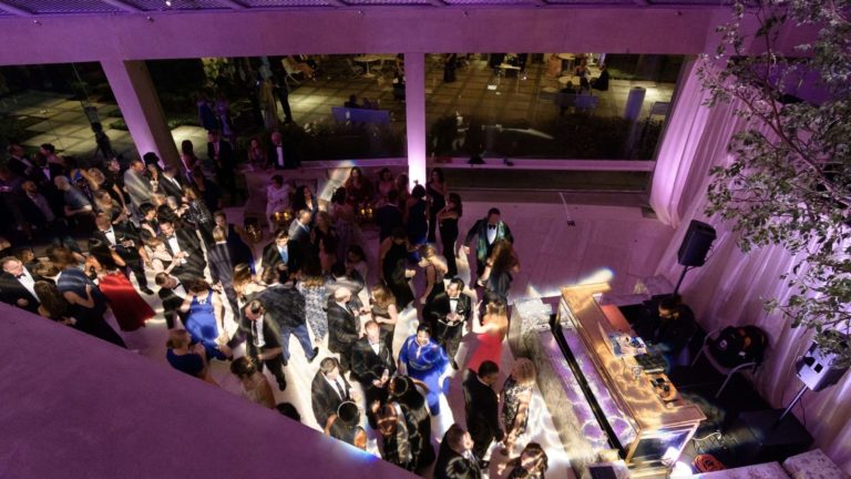 West Lobby dj and dance floor featuring patrons dancing and dramatic lighting