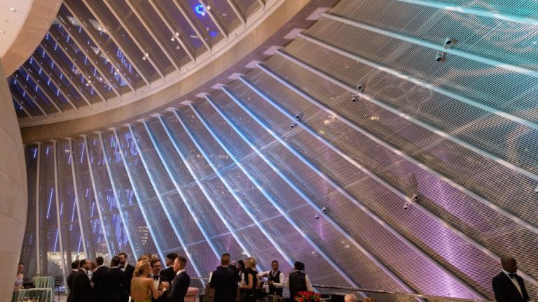 reception area on the loge level with patrons mingling and a light showcase on our large glass walls in the meyerson